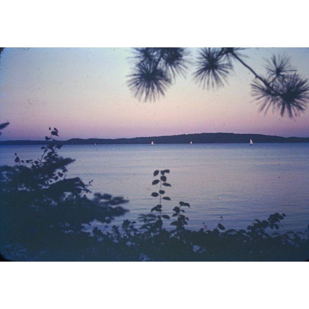 Kodak Slide 35mm 1940s Red Border, a tranquil lake scene at twilight, with boats